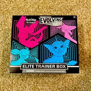 Pokémon Evolving Skies ETB opened with cards and accessories inside.